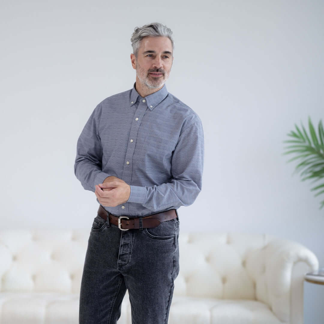 Man wearing a navy plaid long sleeve button-down shirt with magnetic closures, showcasing adaptive fashion.