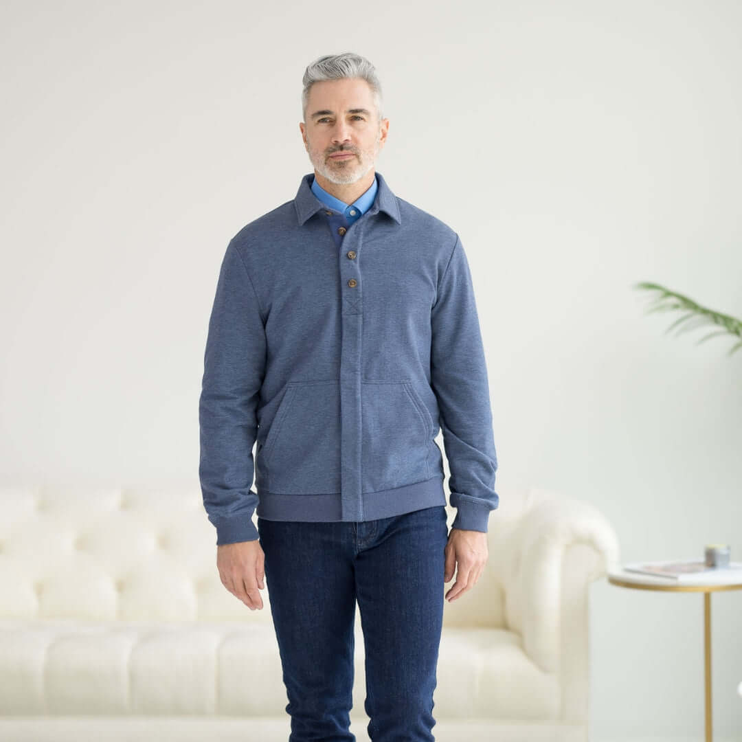Man wearing The Adaptive Magnetic Front Sweatshirt in heathered navy, designed for comfort and mobility support.