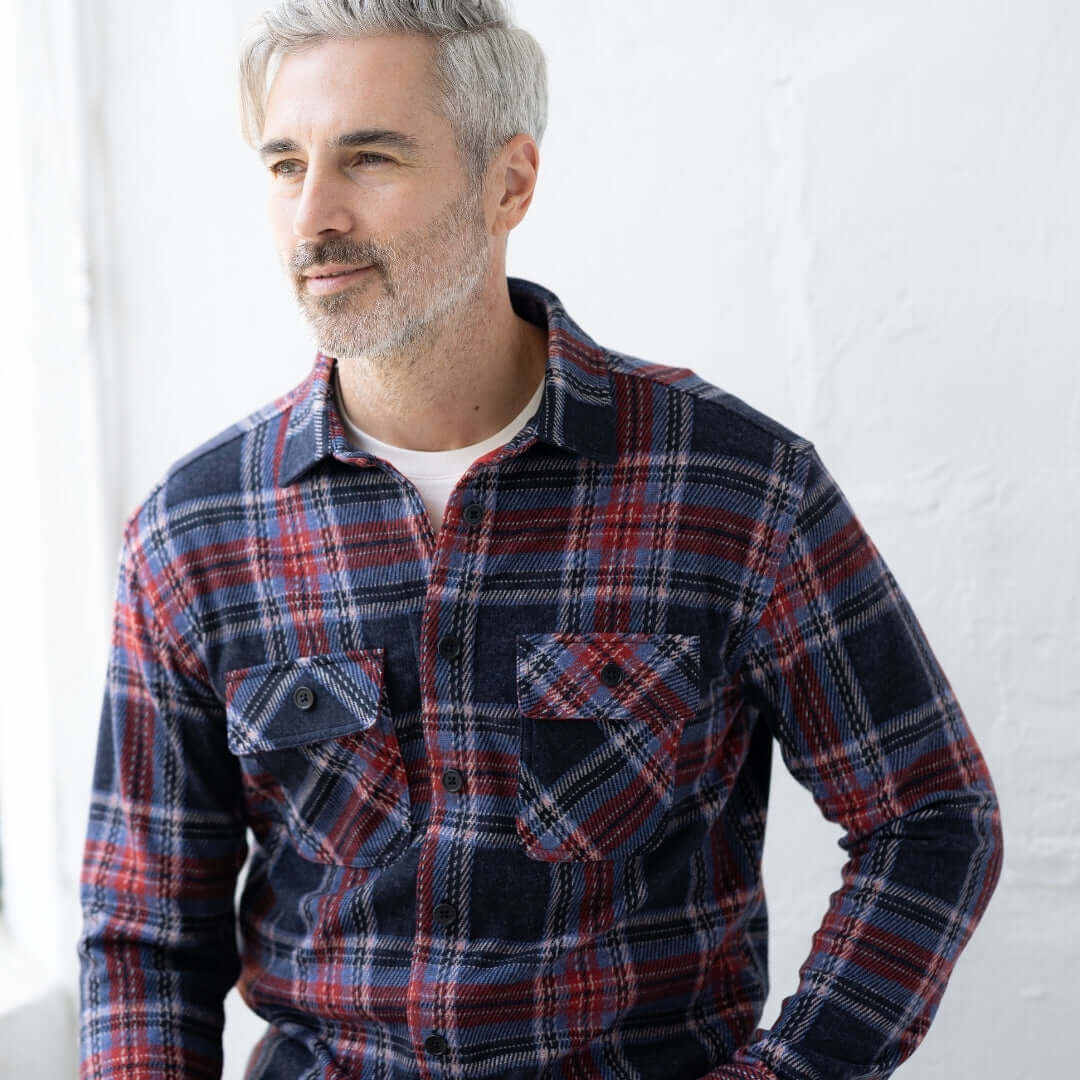 Adaptive Blue and Red Plaid Flannel Shirt with Magnetic Closures worn by a man in a bright setting.