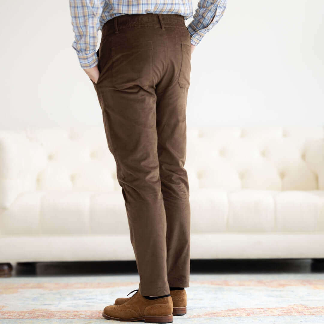 Back view of adaptive brown corduroy pants with discreet pockets, designed for comfort and ease of wear.
