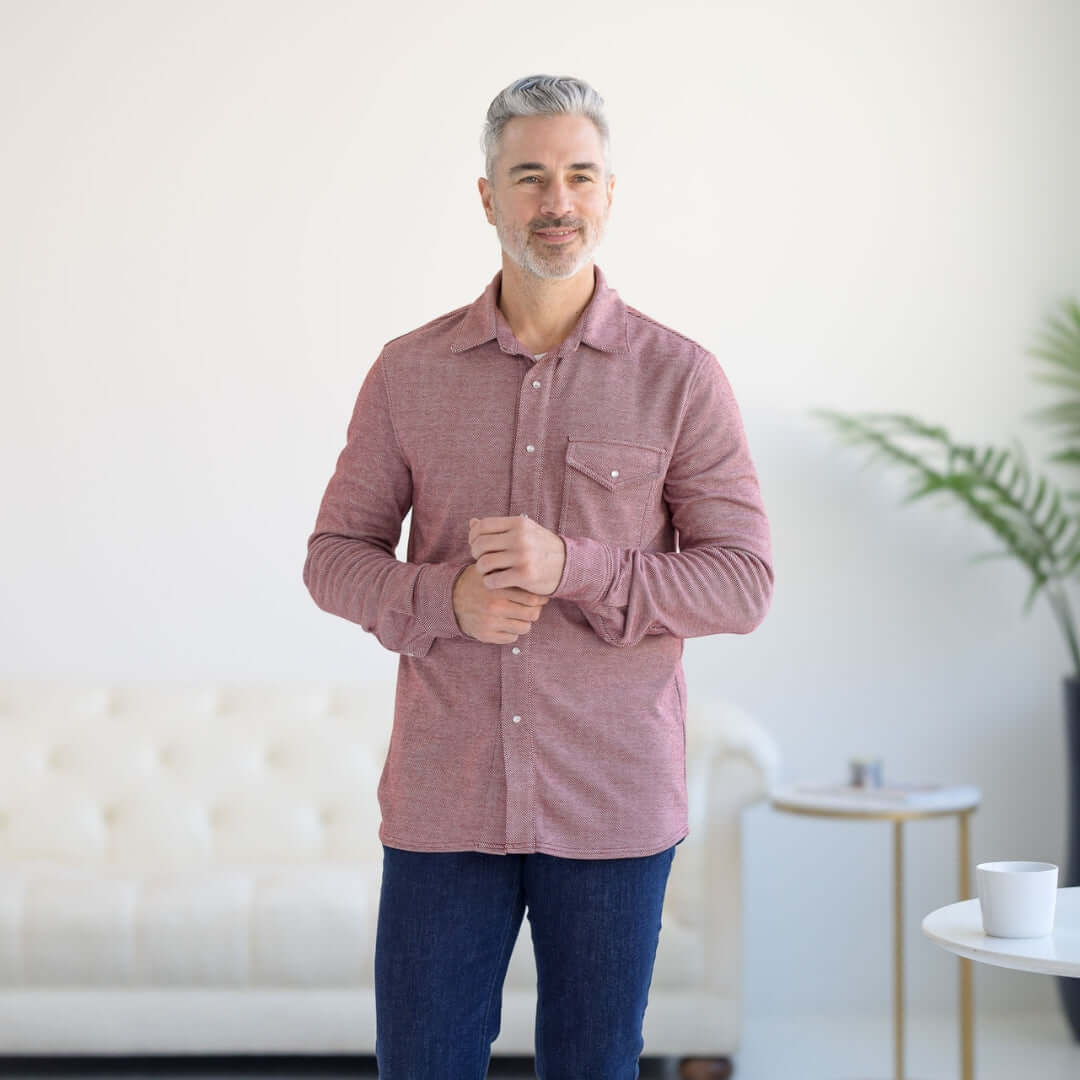 Man wearing a Rio Red adaptive Western twill shirt with magnetic buttons and chest pocket, standing in a modern setting.