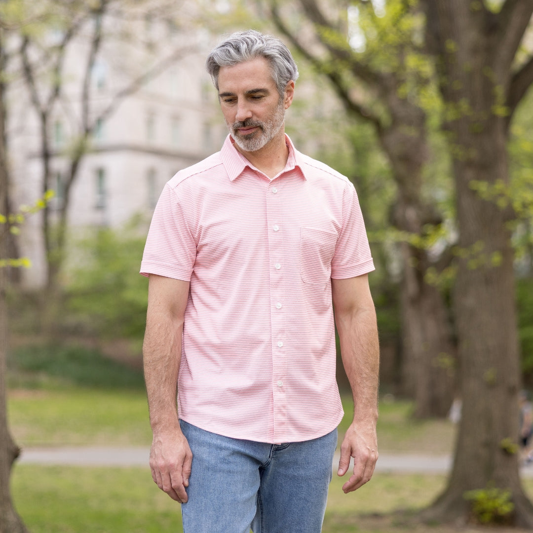 Adaptive Cooling Magnetic Front Short Sleeve Shirt in Coral Stripe worn by a man outdoors in a park.