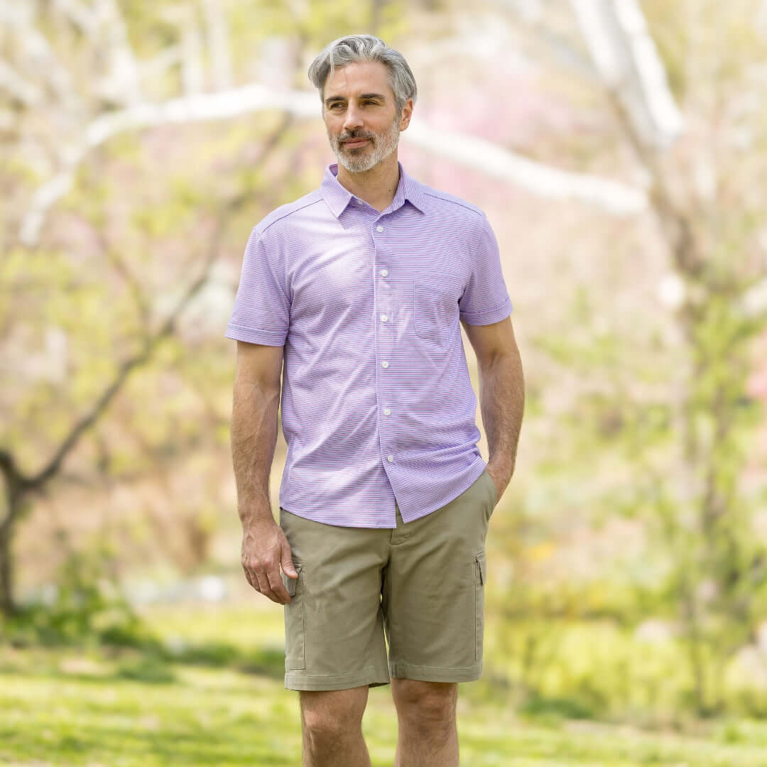 Adaptive Cooling Magnetic Front Short Sleeve Shirt in Pink and Blue Stripe worn outdoors by a man.