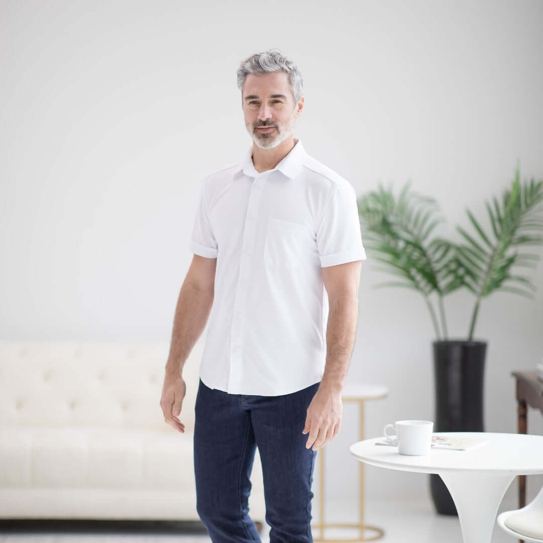 Man in white adaptive cooling polo shirt designed for limited mobility and comfort.