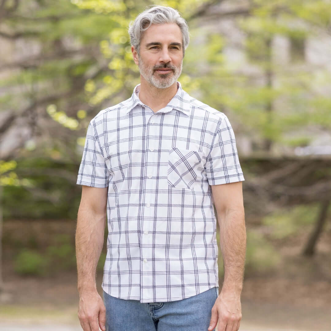 Adaptive Cooling Magnetic Front Short Sleeve Shirt in White Windowpane on a man in a park setting.
