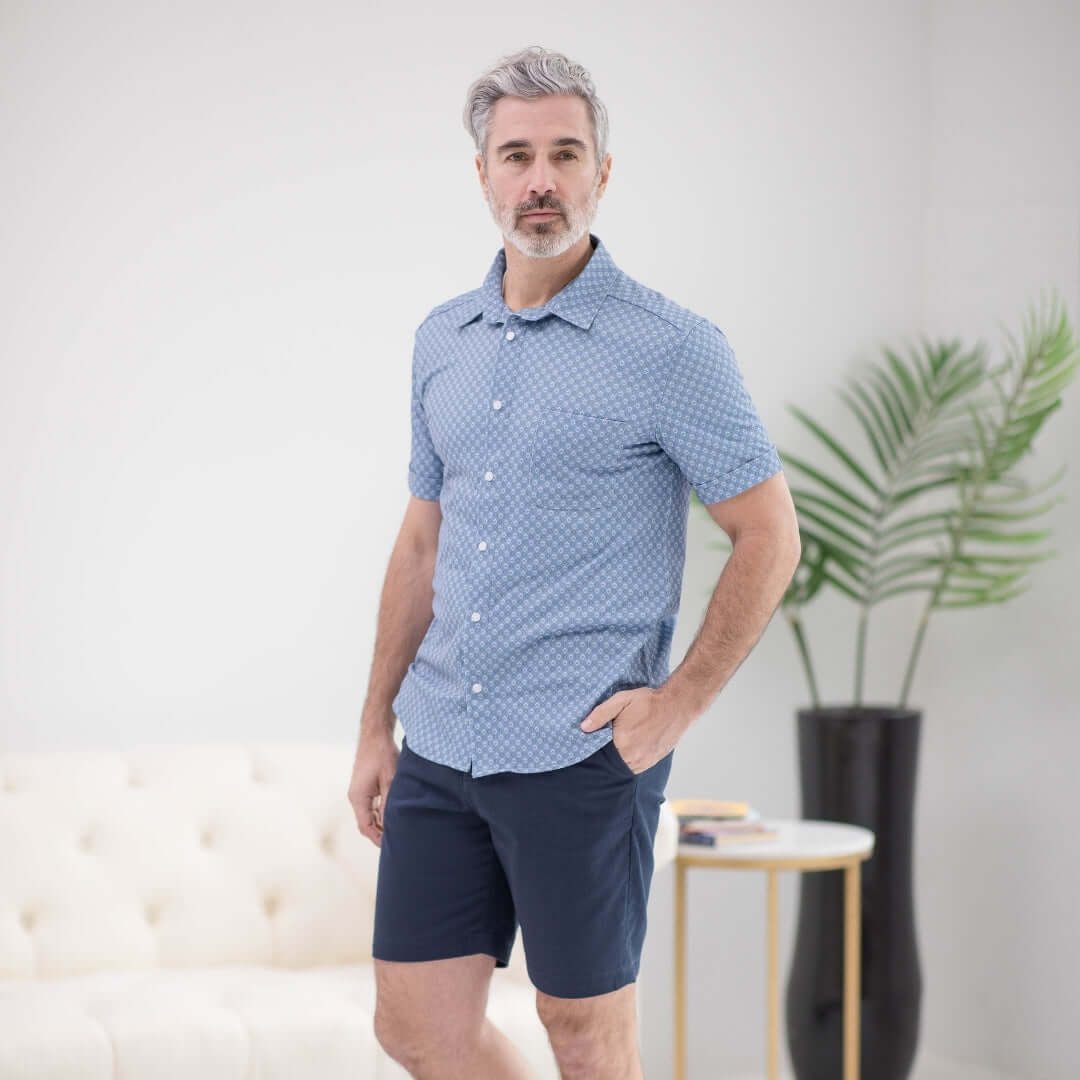 Man wearing a blue diamond patterned adaptive cooling shirt for comfort and mobility support.