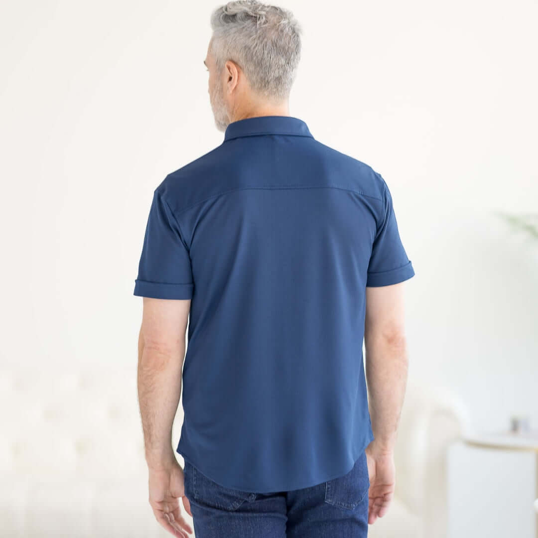 Back view of a man wearing a navy adaptive cooling magnetic short sleeves shirt for comfort and mobility support.