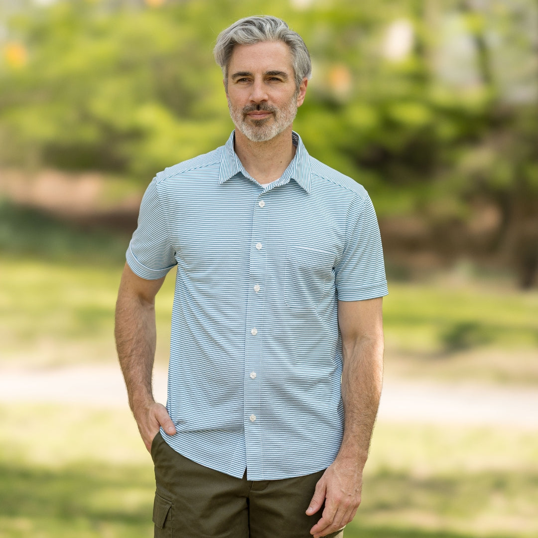 Adaptive Cooling Magnetic Front Short Sleeve Shirt in Green Stripe worn by a man outdoors.