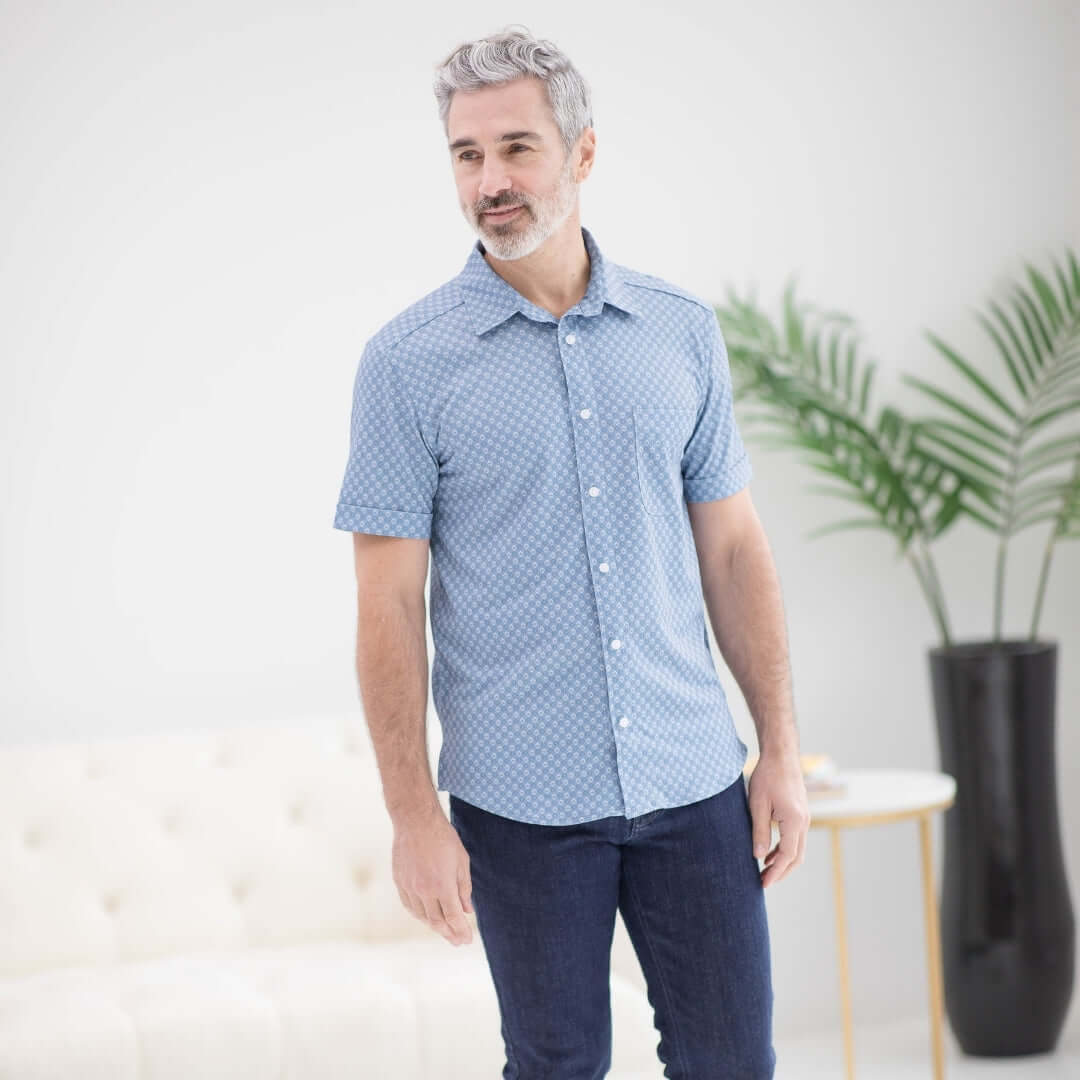 Man wearing adaptive cooling magnetic short sleeves shirt in blue diamond, designed for comfort and independence.
