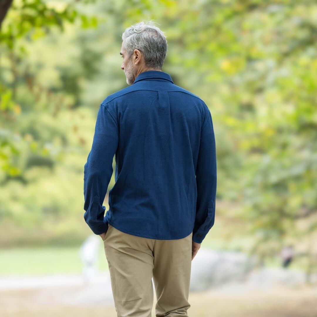 Man wearing an adaptive indigo flannel shirt jacket combo in a natural outdoor setting, looking stylish and comfortable.