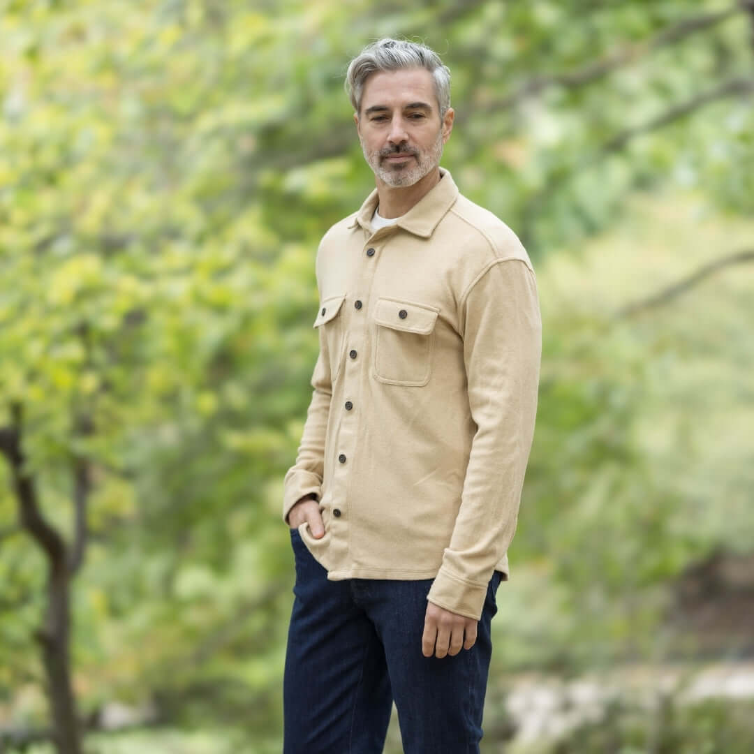 Man wearing an adaptive long sleeve khaki flannel shirt in a natural setting, showcasing style and comfort.