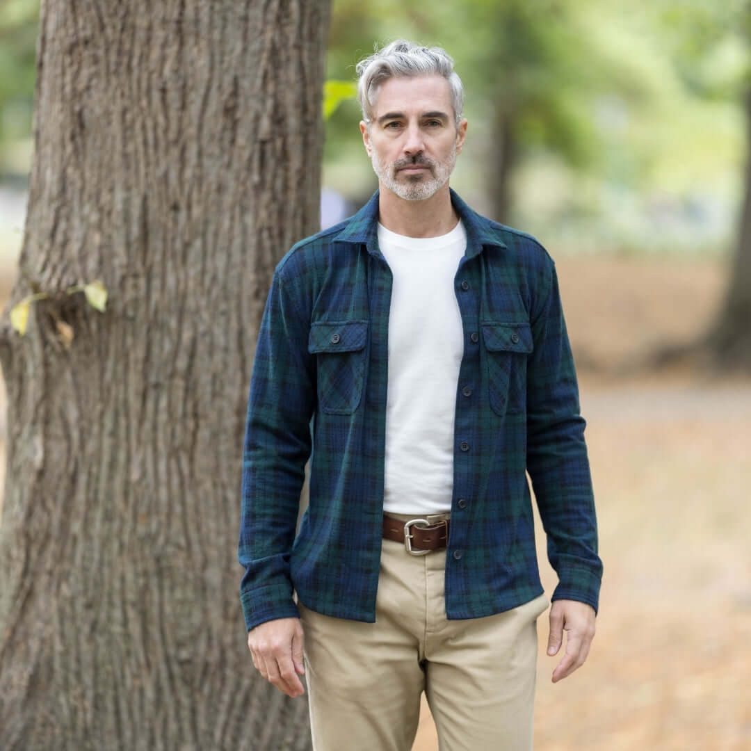 Man wearing adaptive navy and green check flannel shirt outdoors, showcasing style and functionality for fall.