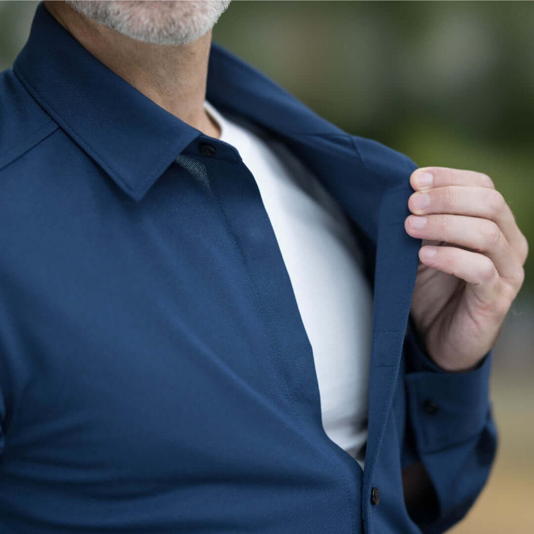Man showcasing a navy long sleeve shirt with magnetic buttons, designed for comfort and easy wear.