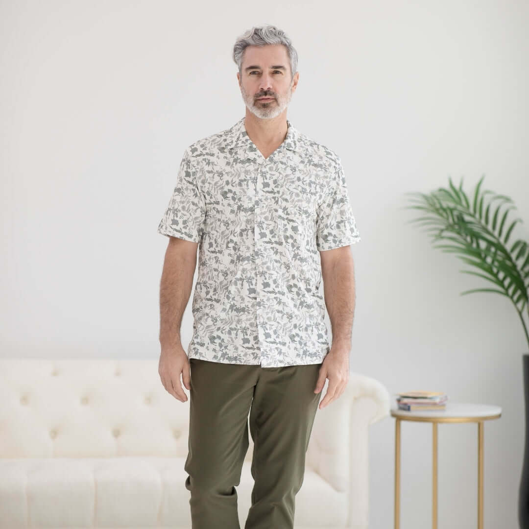 Man wearing a grey floral untucked short sleeve cooling shirt, designed for comfort and accessibility for various mobility needs.