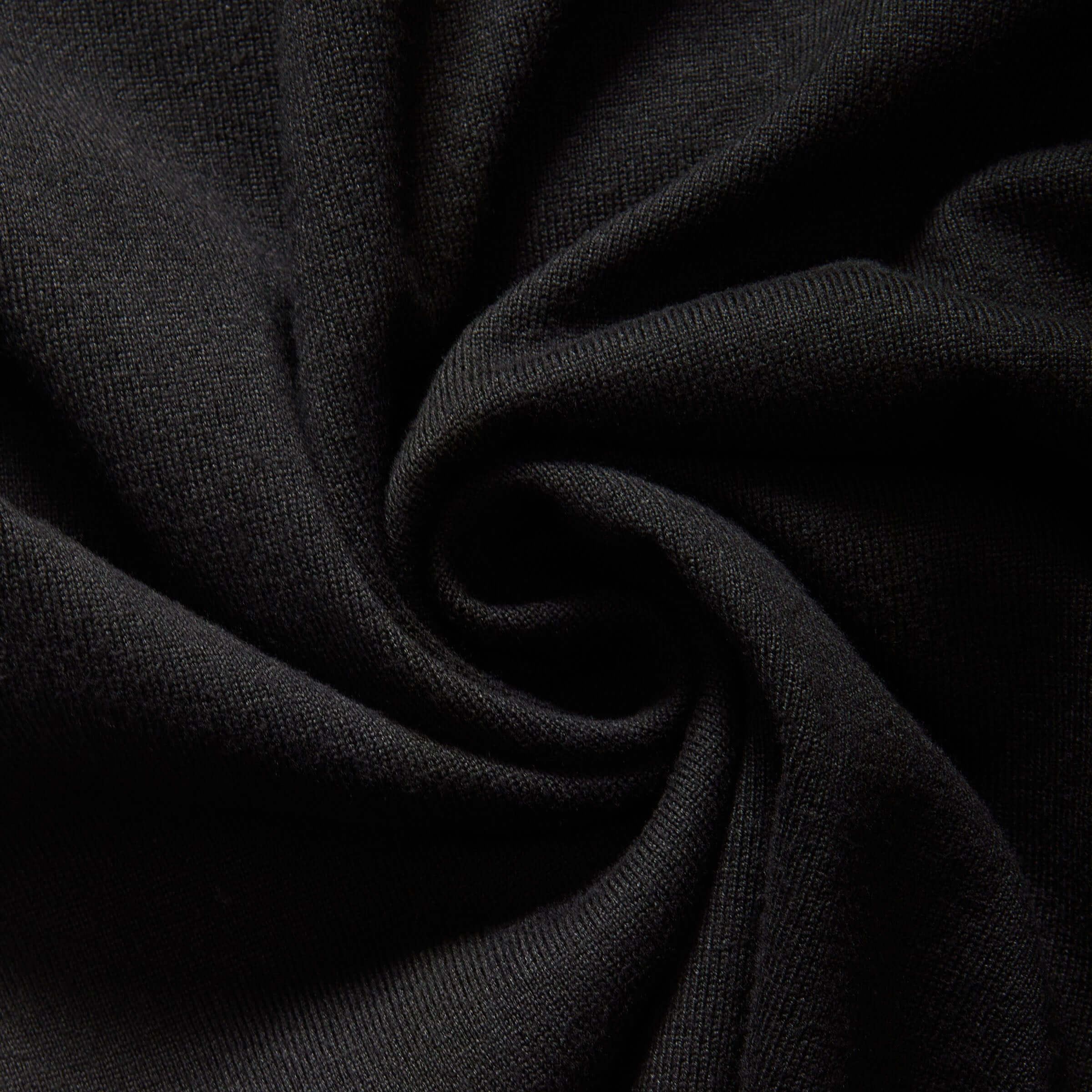 Close-up of soft black knit fabric, showcasing texture for women's adaptive cardigan sweater.