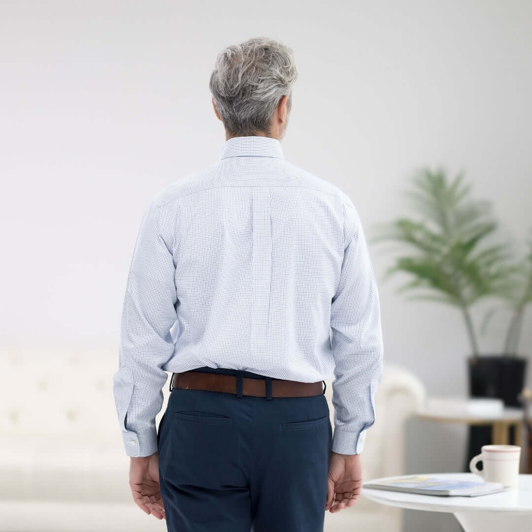 Back view of a man in a Brooks Brothers x MagnaReady blue and white check long sleeve shirt, featuring magnetic closures.