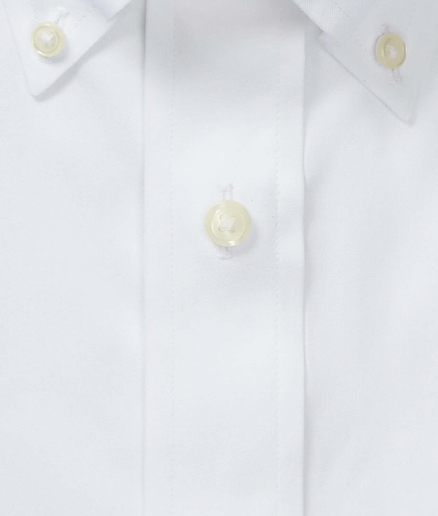Close-up of white button-down polo shirt collar with button closures, showcasing Brooks Brothers x MagnaReady design.