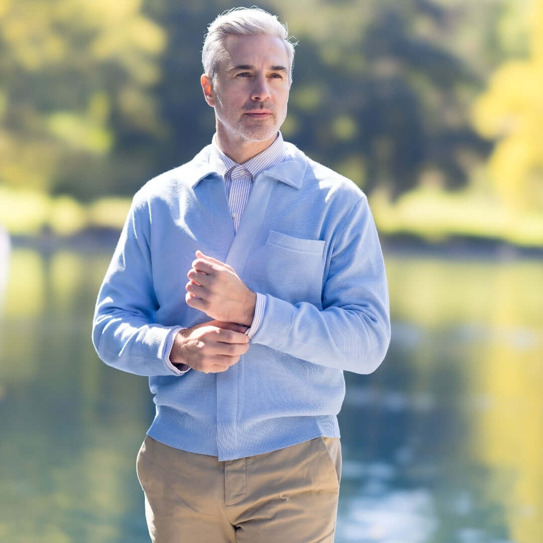 Classic Blue Adaptive Sweater with Magnetic Front Closure with Pocket worn by a man outdoors near water.