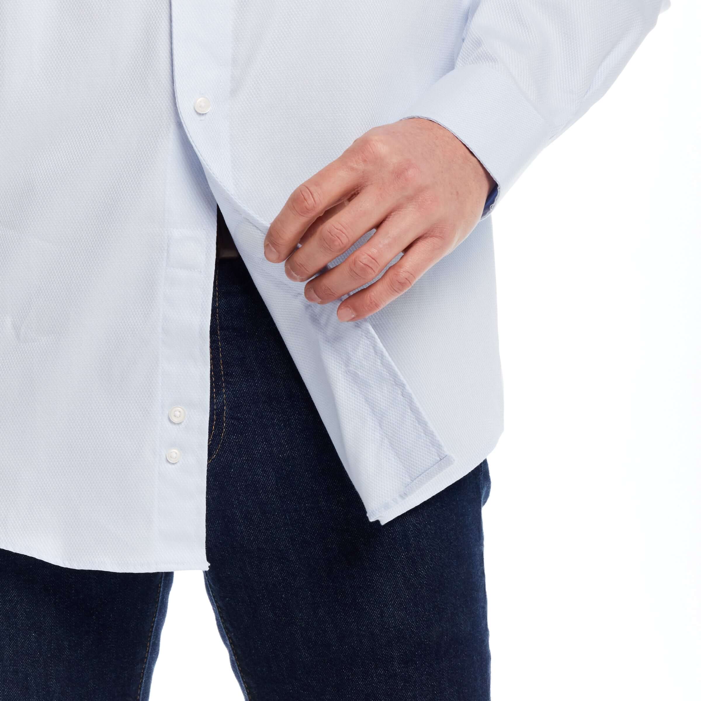 Close-up of a man wearing a light blue adaptive dress shirt, highlighting magnetic closures and traditional fit.