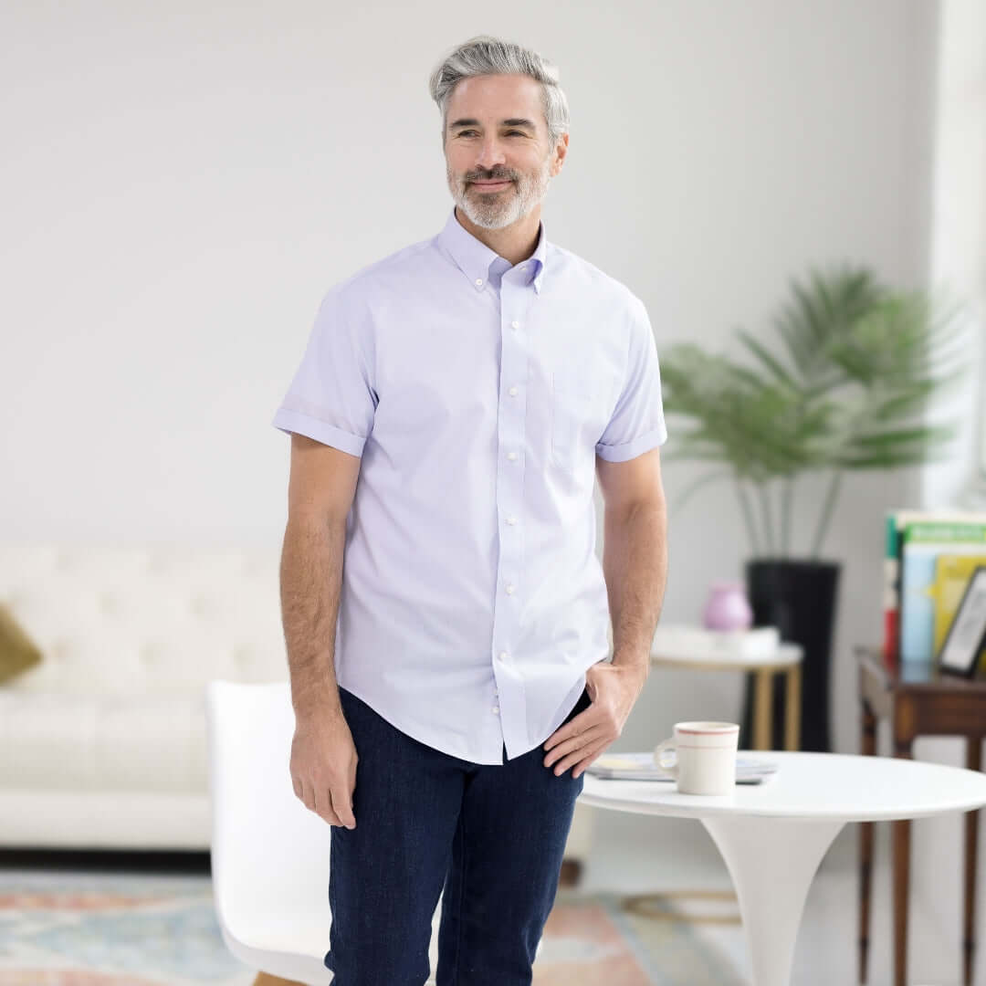 Lavender short sleeve button-down collar shirt styled with modern elegance in a bright indoor setting.