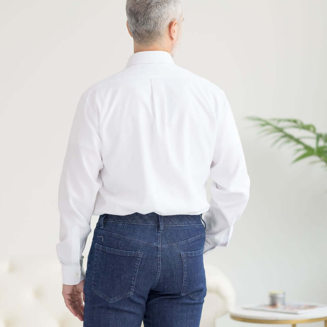 Back view of a man wearing a Long Sleeve White 'Ryan' Dress Shirt with Magnetic Closures and blue jeans.