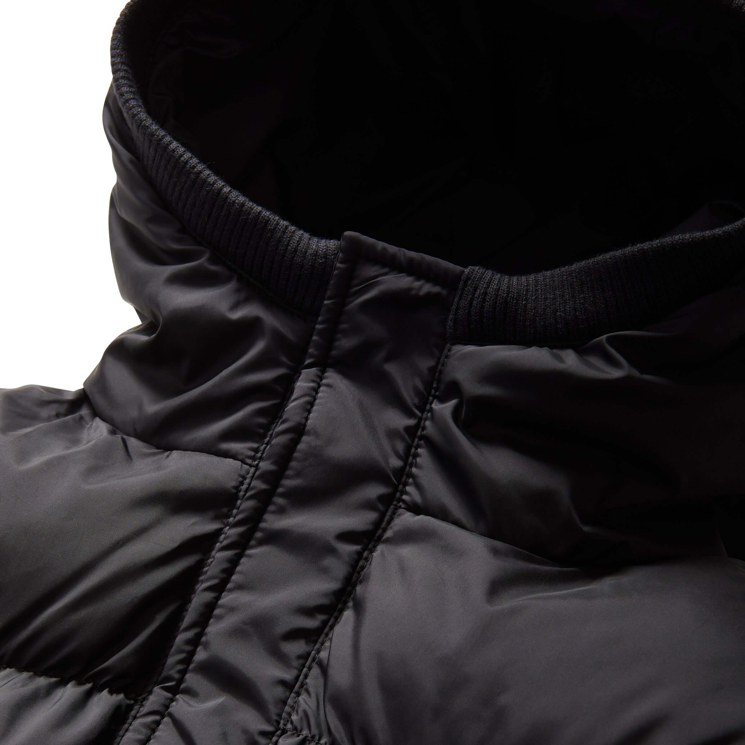 Close-up of the black MagnaMini kids puffer coat hood, showcasing water-resistant fabric and cozy design.