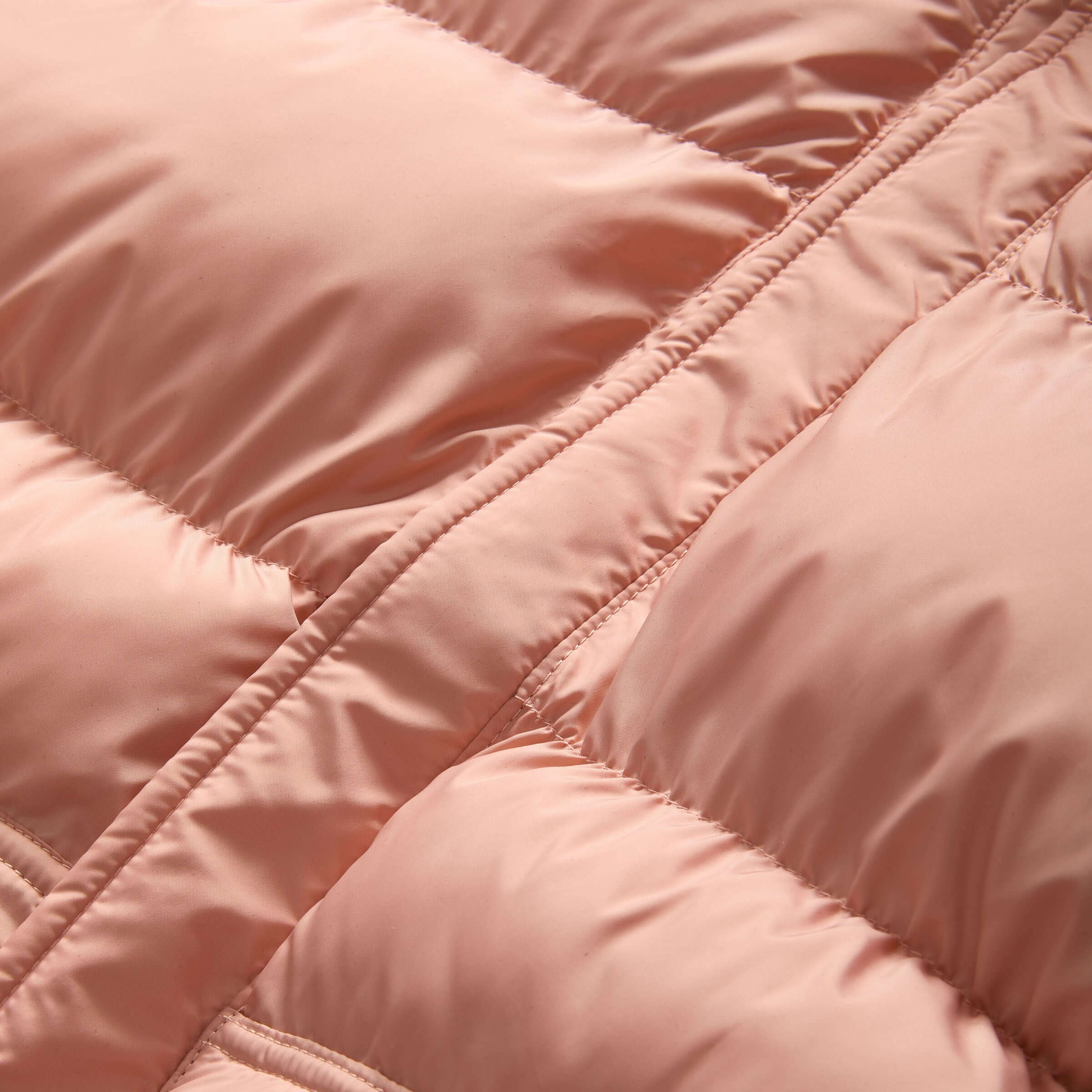 Close-up of the soft, pink fabric of the MagnaMini kids' water-resistant puffer coat.