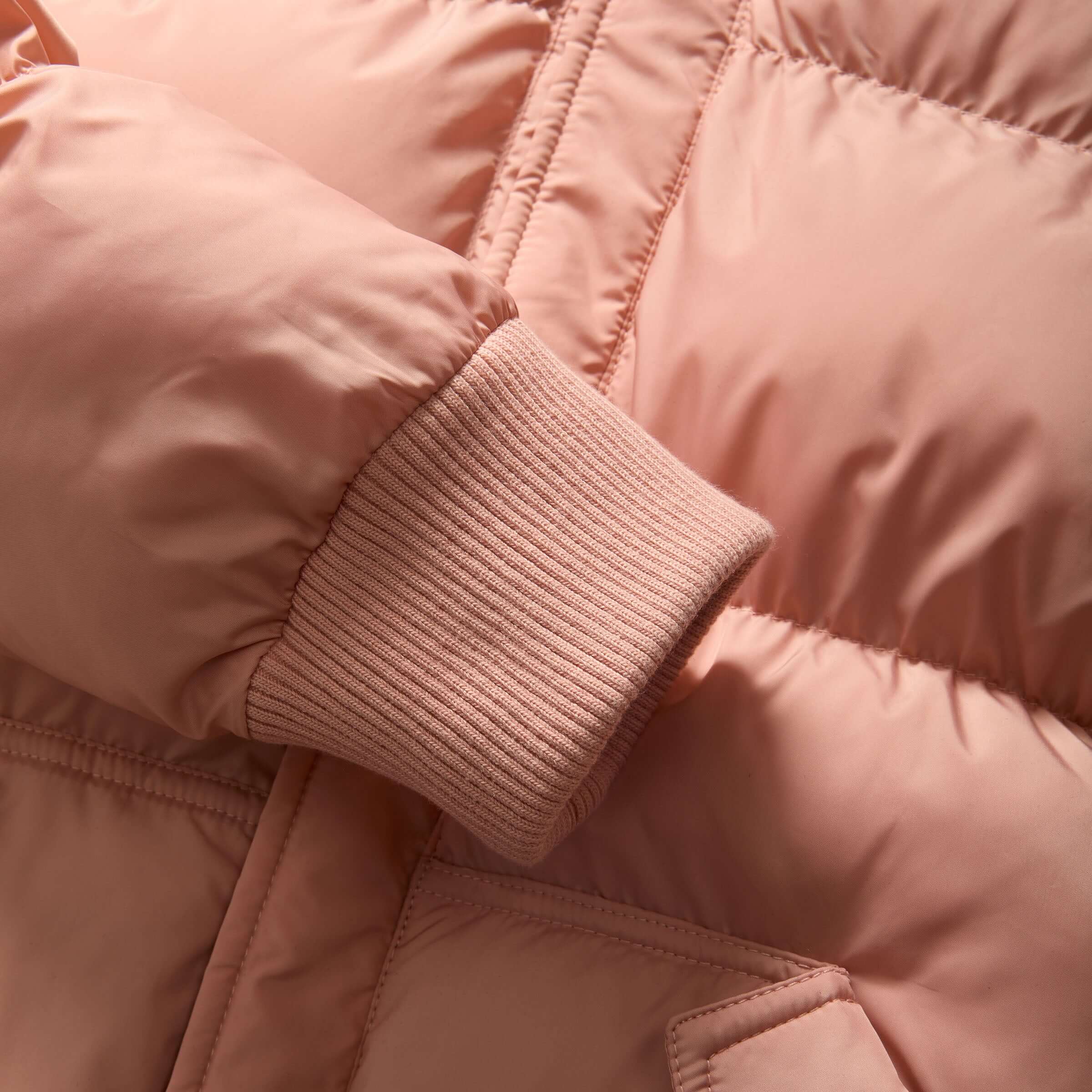 Close-up of the pink MagnaMini kids' puffer coat sleeve with ribbed cuff, highlighting its soft and cozy texture.
