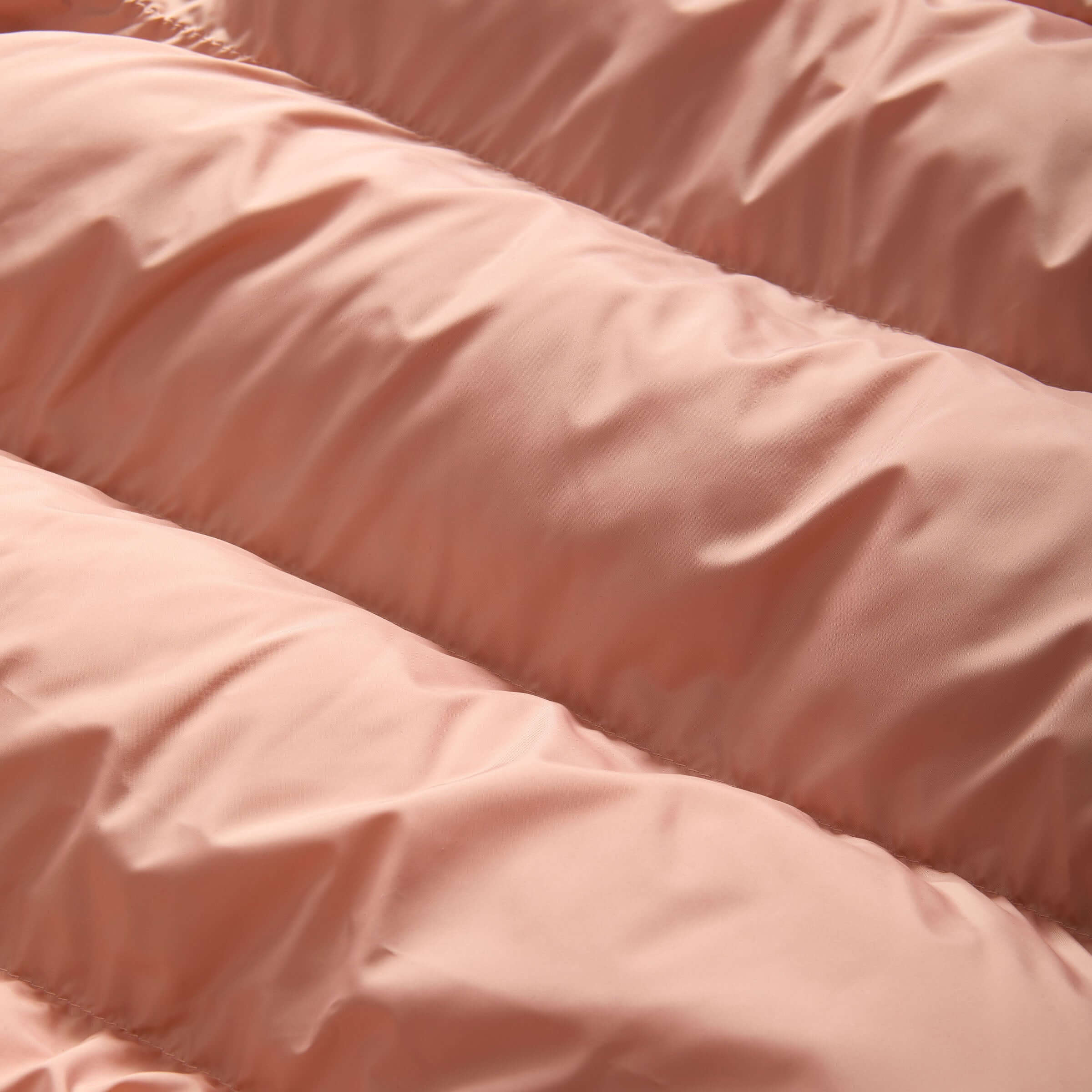 Close-up of pink puffer coat fabric, showcasing the water-resistant material and insulated design for kids.