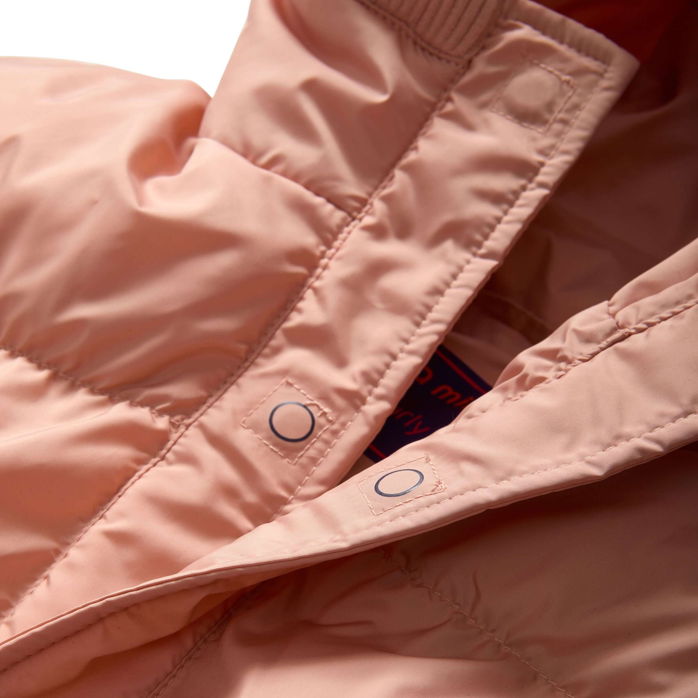 Close-up of the MagnaMini kids puffer coat in pink, showcasing the warm, water-resistant fabric and magnetic closure.