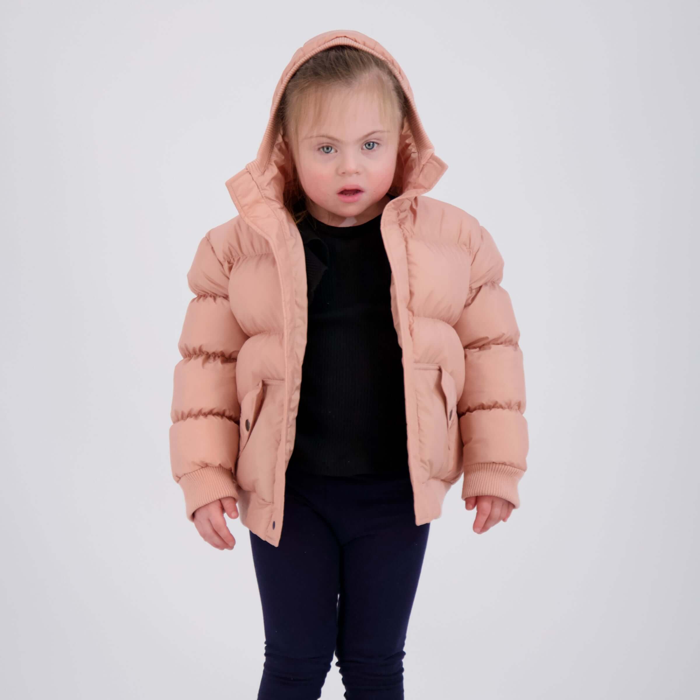 MagnaMini kids pink water-resistant puffer coat with hood worn by a girl, showcasing easy magnetic closures.