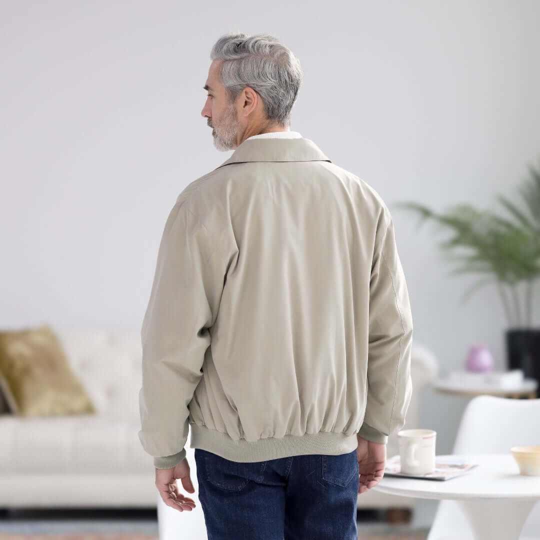 Man wearing a MagnaReady x Weatherproof classic magnetized golf jacket in new stone, showcasing the back design.