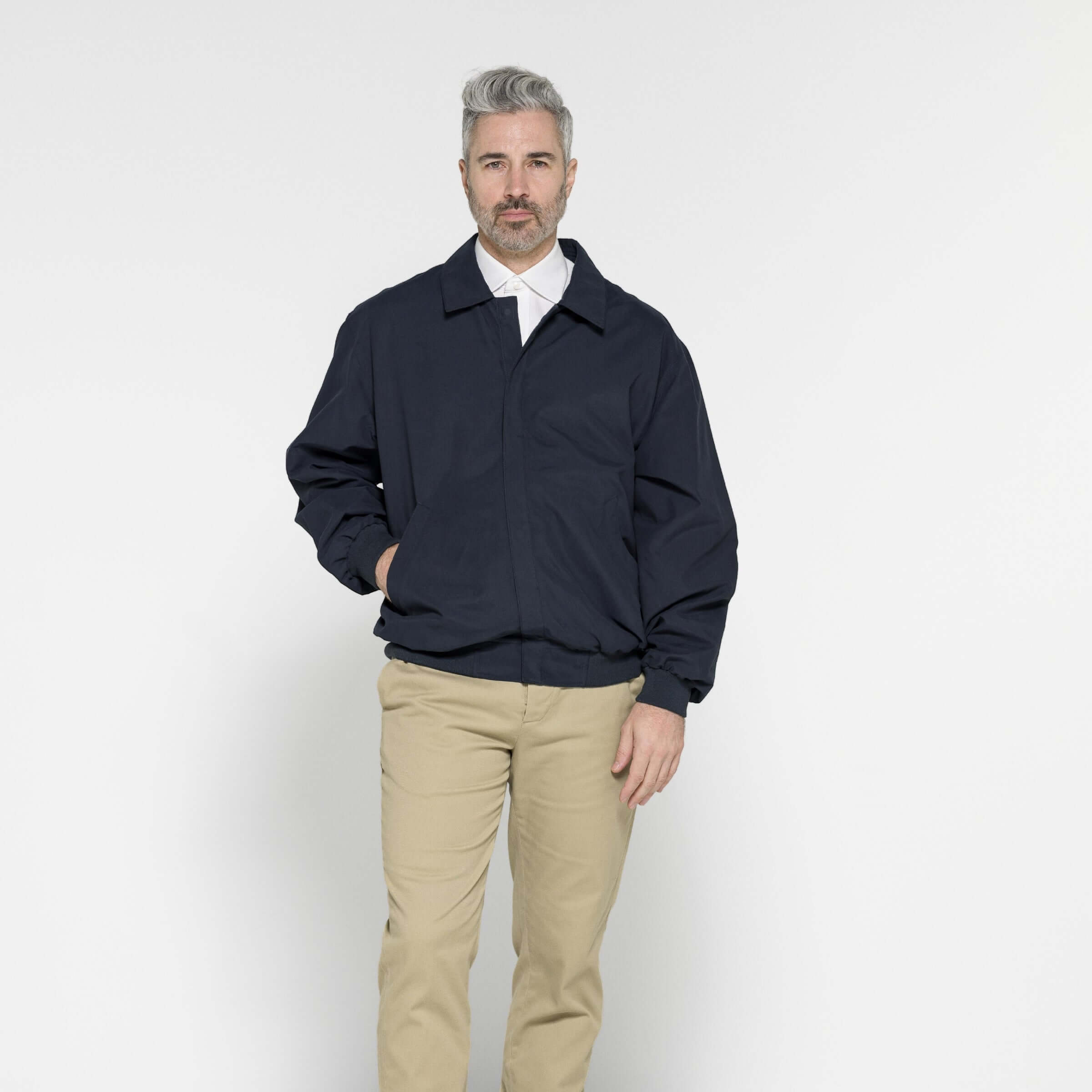 Man modeling a navy MagnaReady® X Weatherproof Golf Jacket, showcasing adaptive and stylish design.