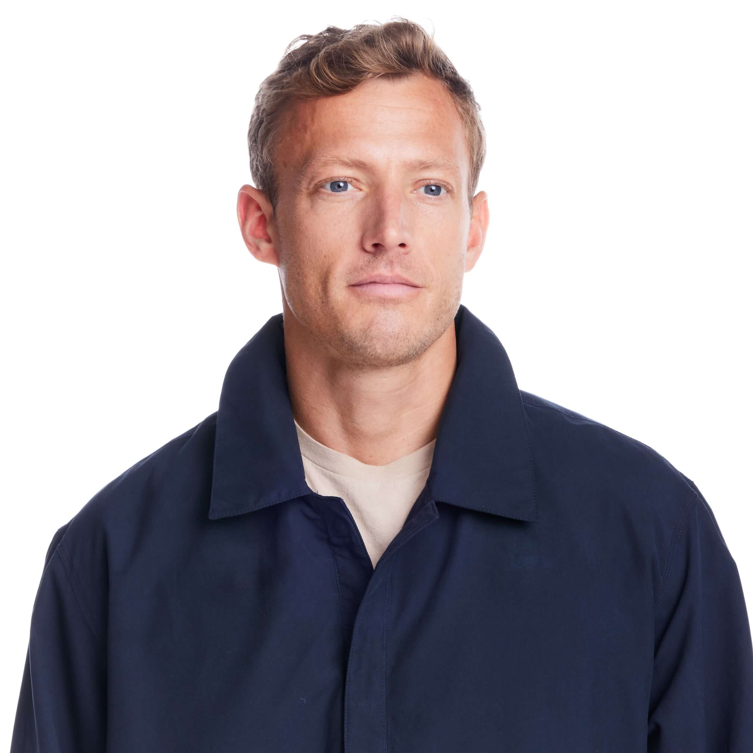 Man wearing the MagnaReady® X Weatherproof Navy Golf Jacket, designed for accessibility and style.