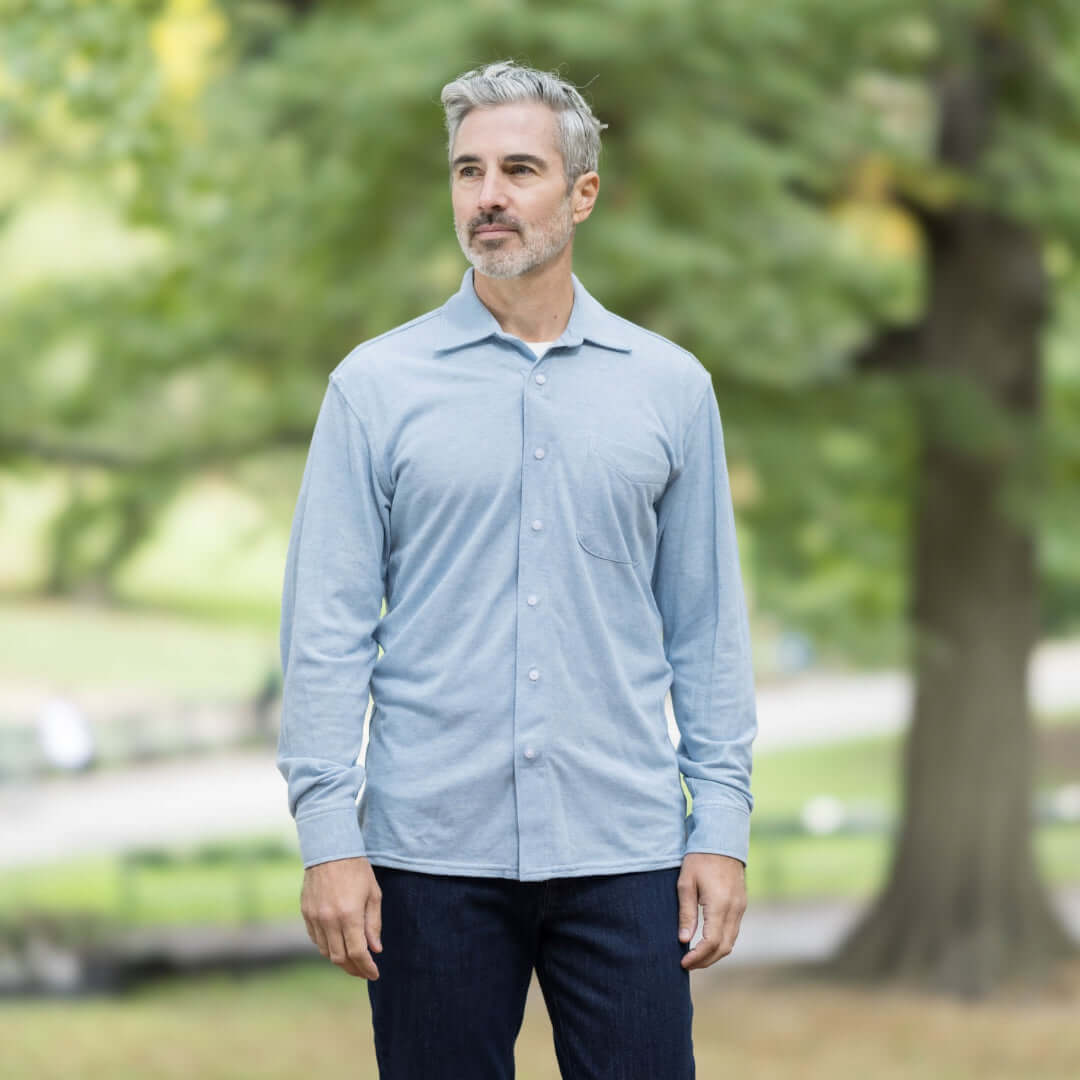 Man wearing a sky blue long sleeve Oxford shirt with pocket, showcasing MagnaReady technology outdoors.