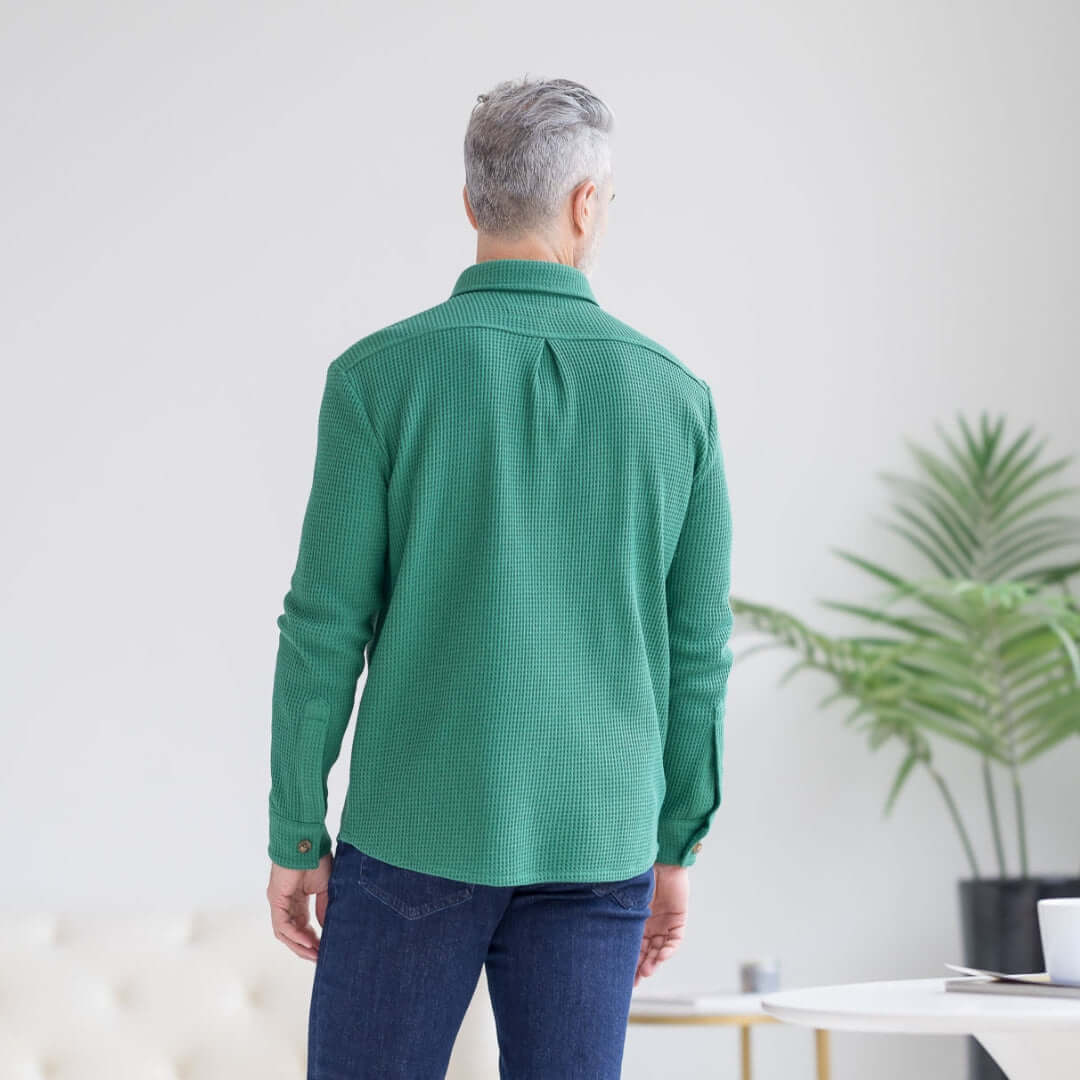 Back view of a man wearing a green waffle weave casual shirt, showcasing dual oversized pockets.