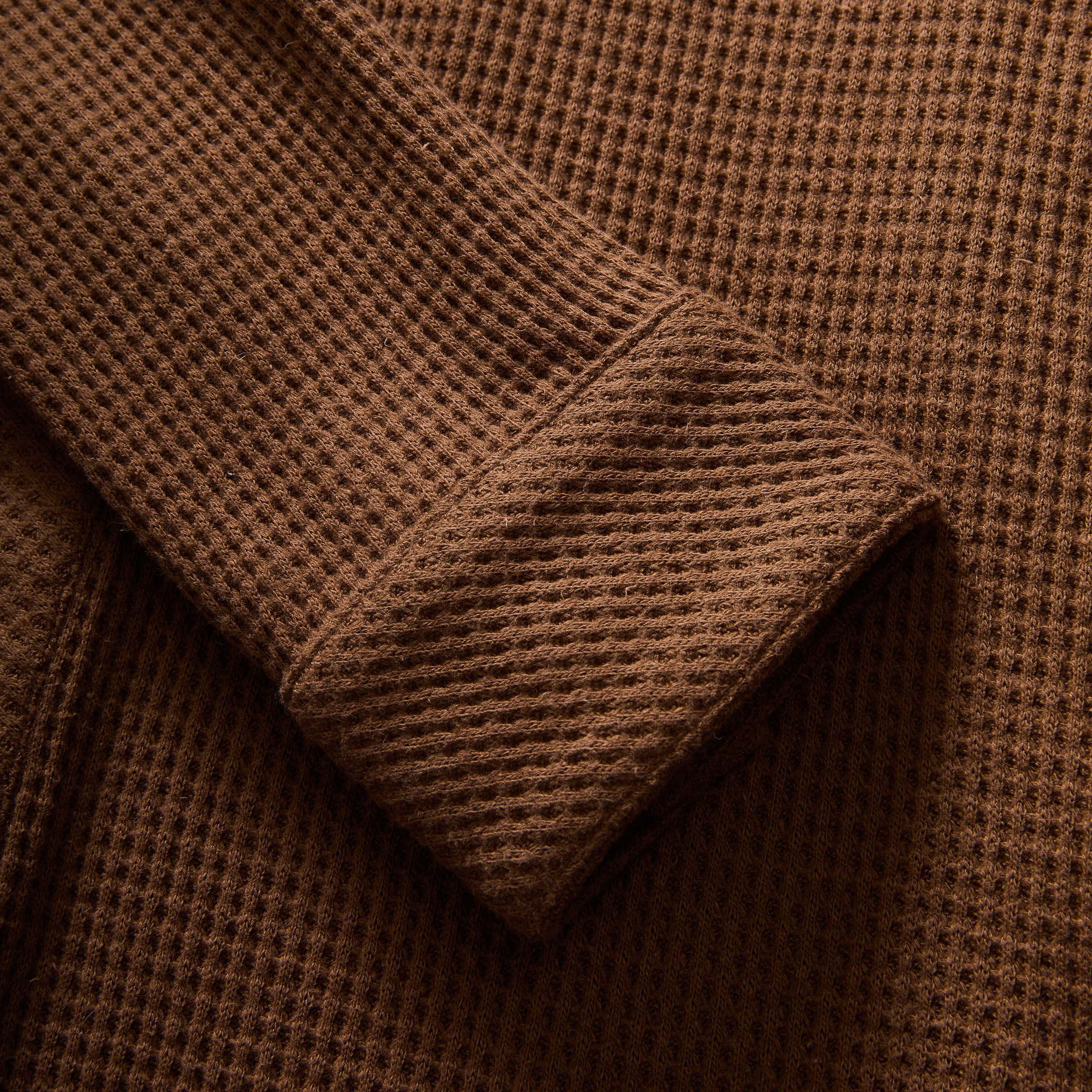 Close-up of the sleeve of a brown waffle knit casual shirt showcasing its soft texture.