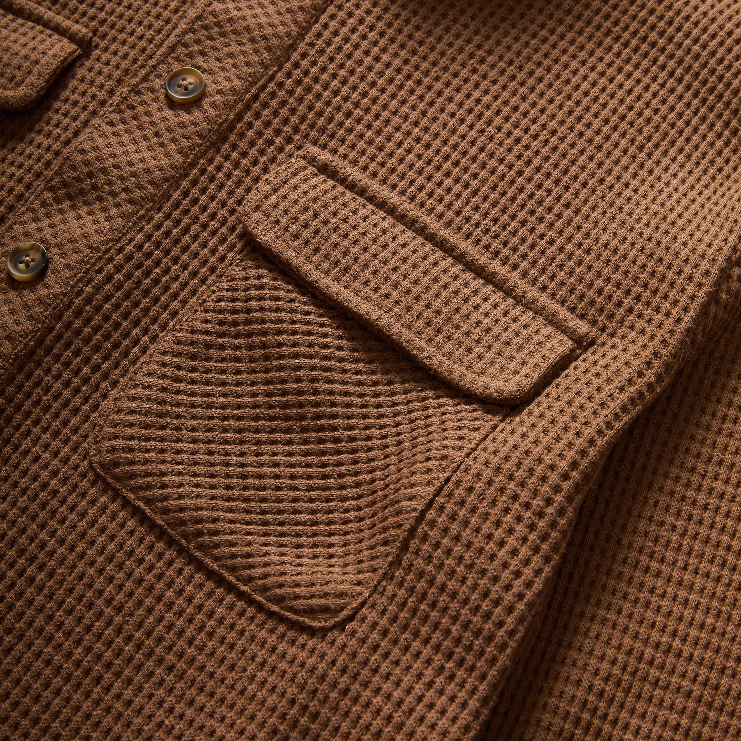 Close-up of magnetic front button and pocket detail on brown WaffleWeave casual shirt.