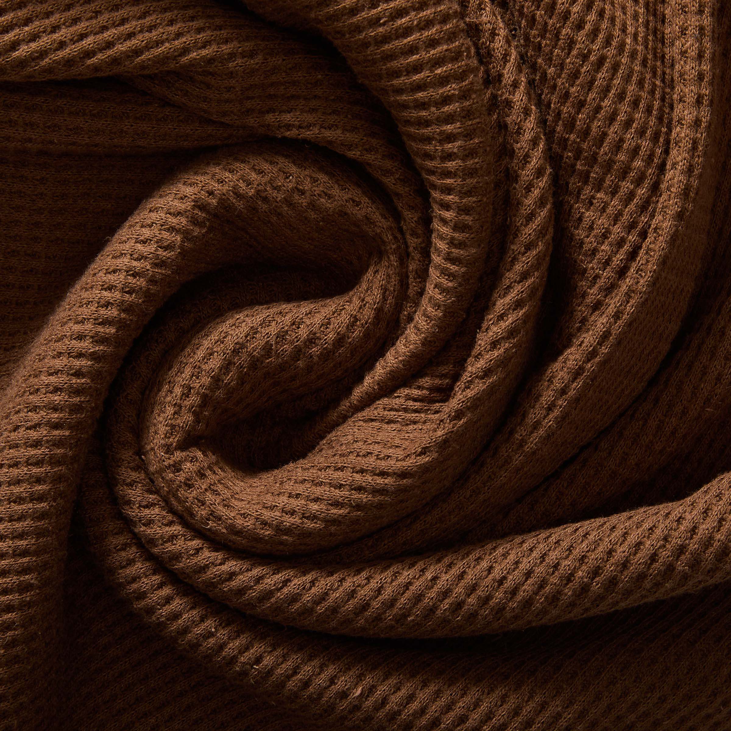 Close-up of soft choco waffle weave fabric, showcasing texture and warmth for casual wear.