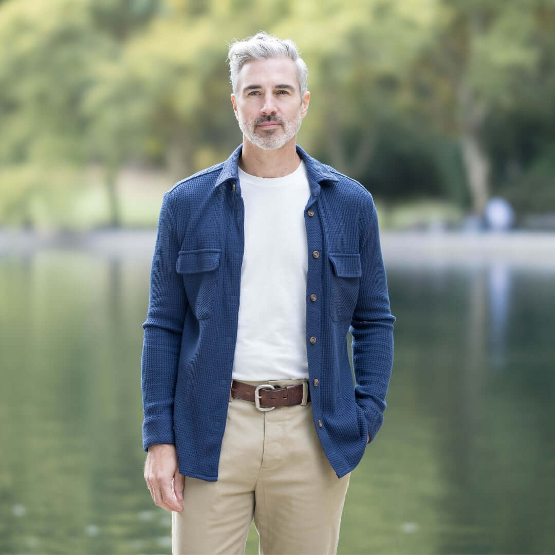 Man wearing navy Magnetic Front WaffleWeave Casual Shirt with dual pockets by a serene lake.