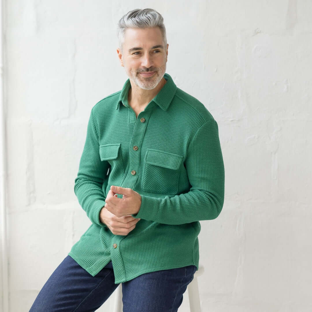 Man wearing a green waffle weave casual shirt with dual oversized pockets, designed for comfort and limited mobility.