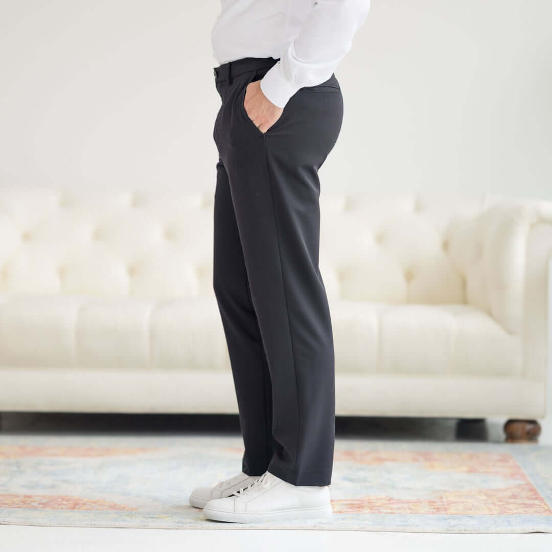 Side view of Nautica x MagnaReady Adaptive Fly Stretch Dress Pant in black, styled with white sneakers.