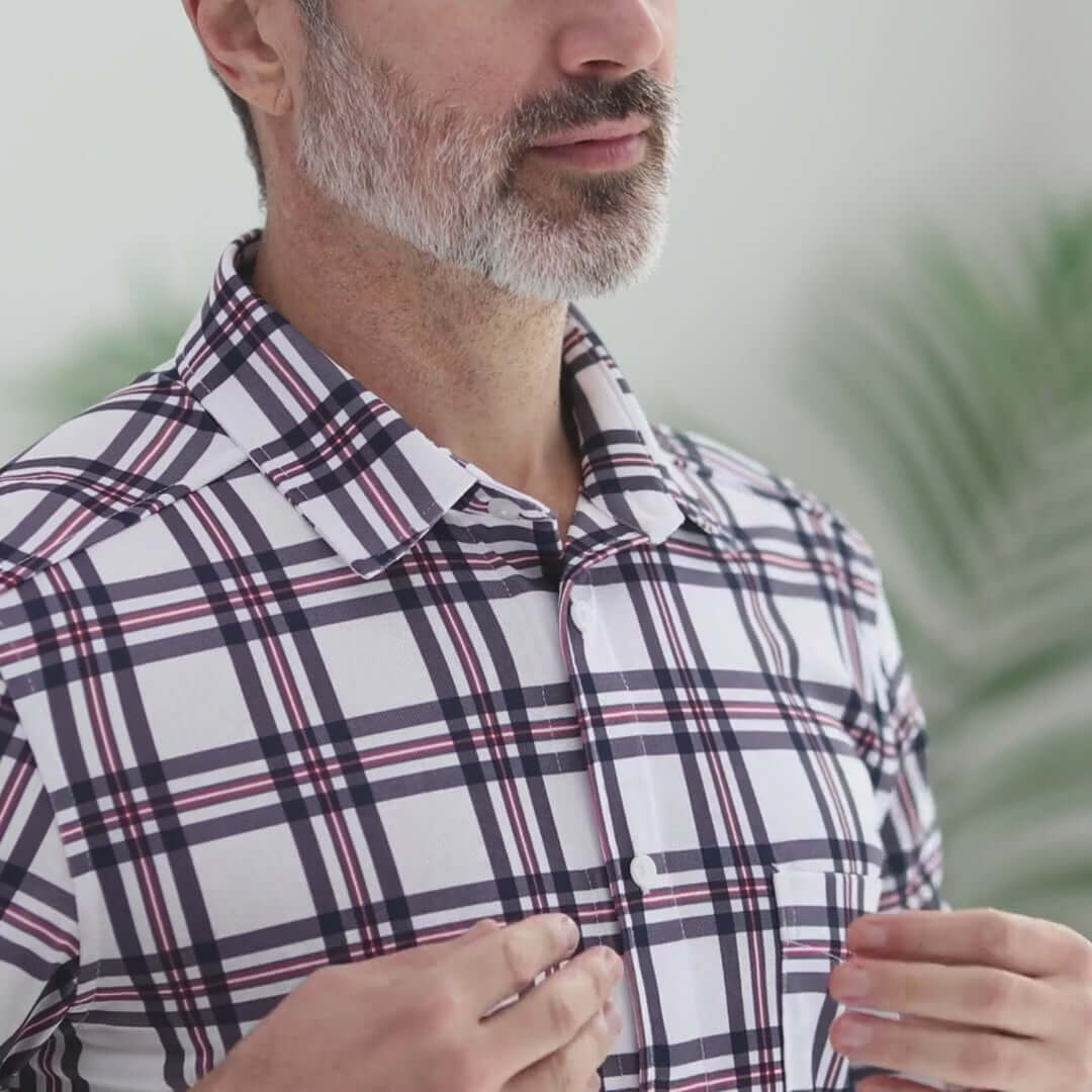 Man wearing an adaptive cooling magnetic short sleeves shirt with plaid design, demonstrating comfort and style.