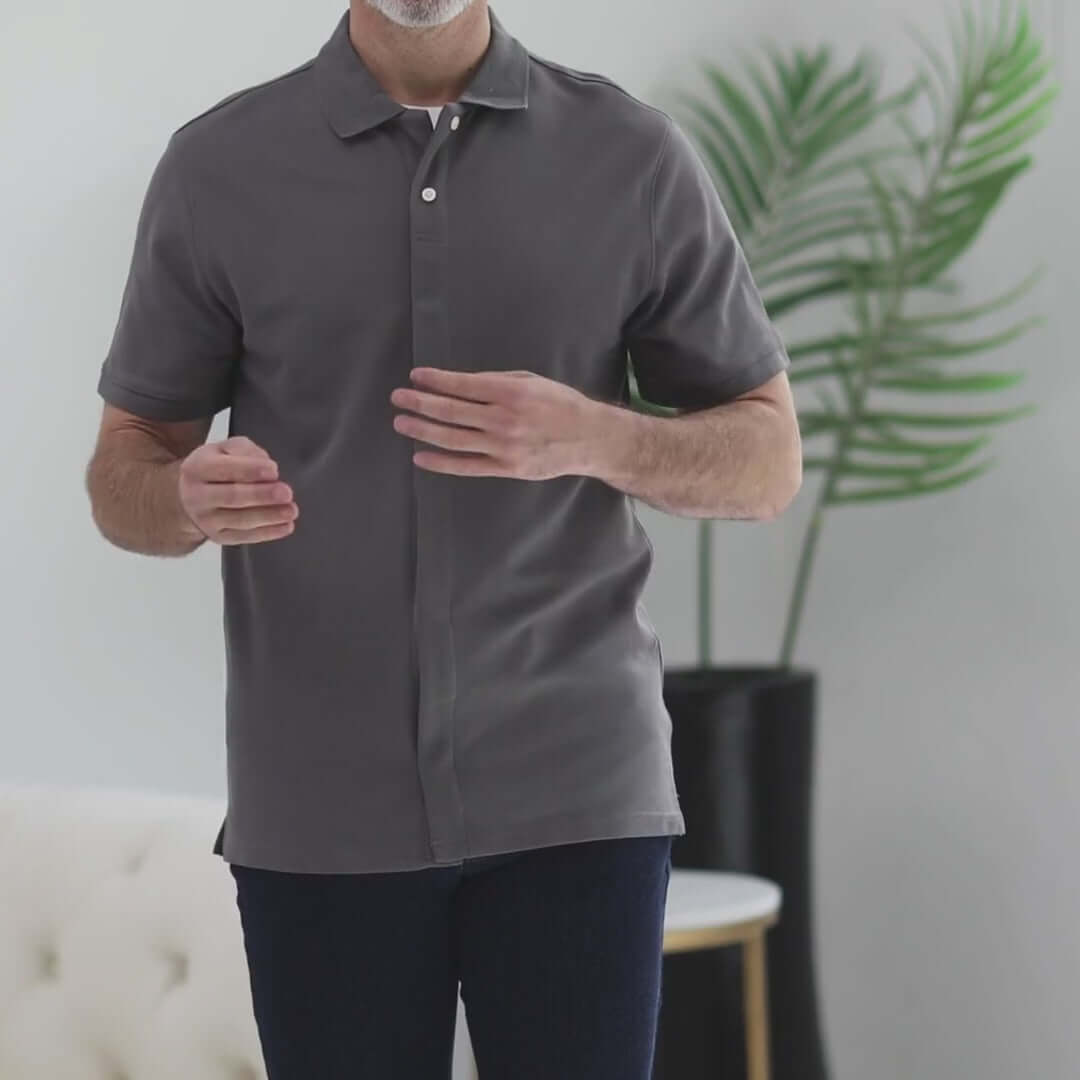 Grey pique knit short sleeve polo shirt with magnetic closures for easy dressing.