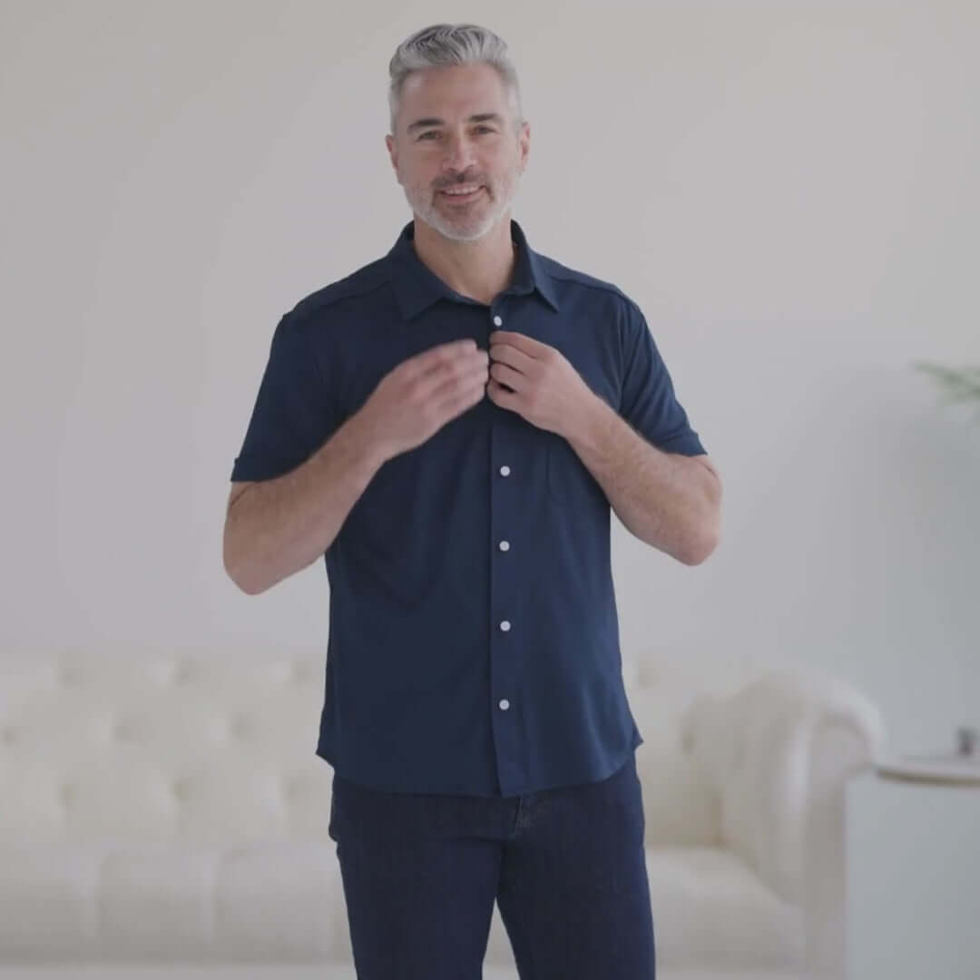 Man wearing an adaptive cooling magnetic front short sleeves shirt in navy, designed for comfort and mobility.