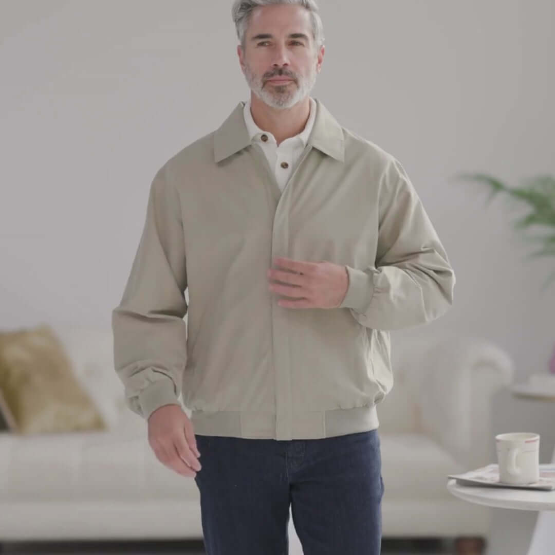 Man wearing the MagnaReady x Weatherproof Classic Golf Jacket in New Stone, showcasing modern style and accessible design.