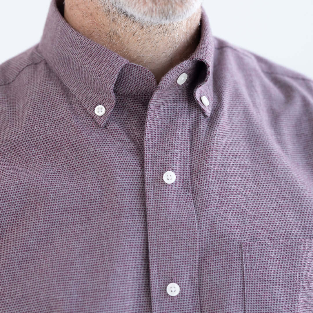 Red and grey long sleeve button down collar shirt with magnetic closures, designed for ease and independence.