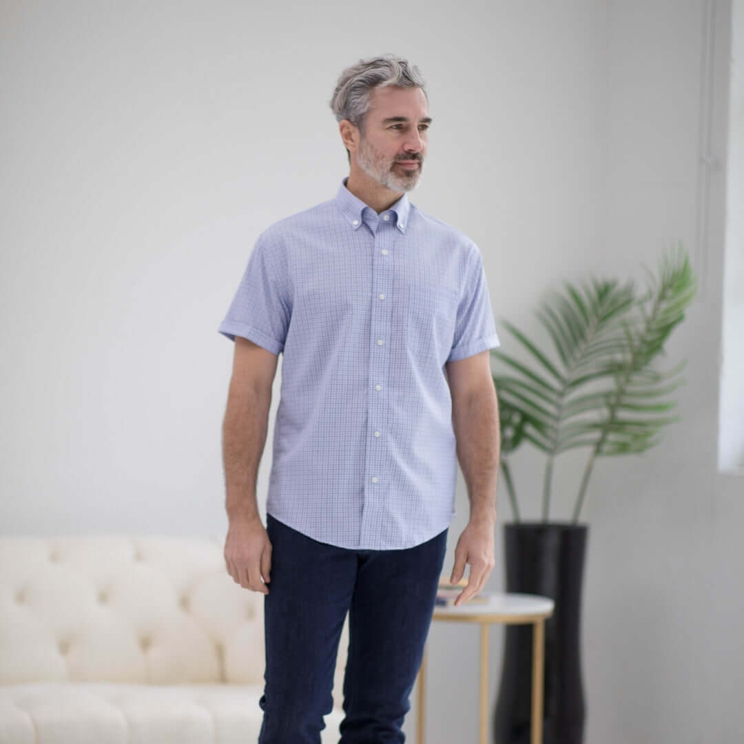 Man wearing a short sleeve blue and red check cotton shirt with a pocket, showcasing comfort and style.