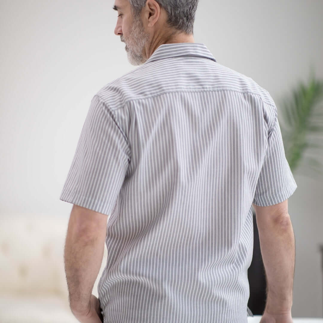 Rear view of man wearing a grey striped short sleeve untucked 'Landry' camp collar shirt.