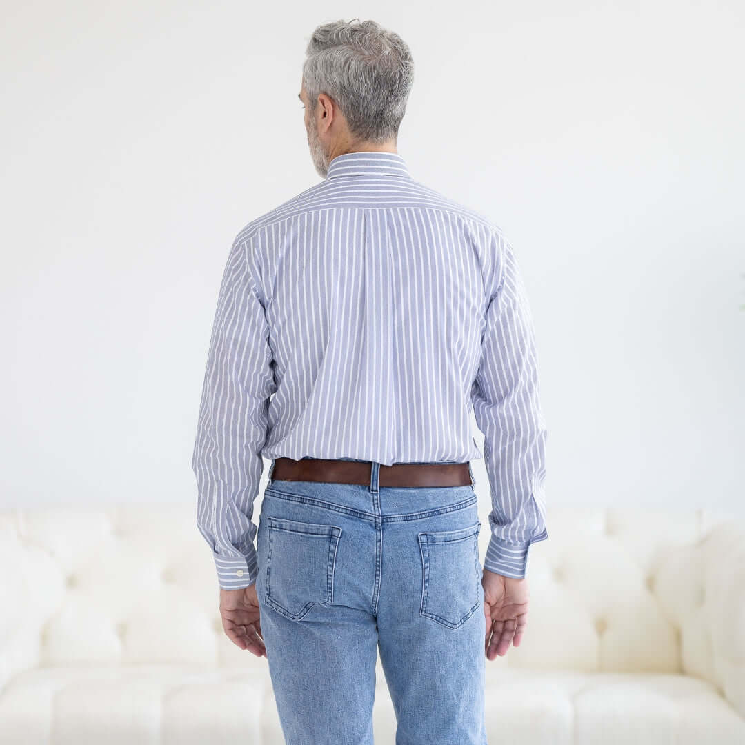 Back view of a man wearing a blue stripe button-down dress shirt with magnetic closures, designed for easy wear.